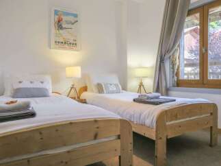 This charming bedroom features two cozy twin beds, perfect for a comfortable stay.
