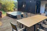 Enjoy luxurious outdoor living with this stunning property featuring a hot tub and a spacious deck.