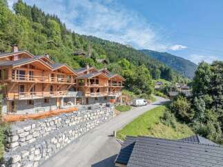 Discover the charm of these stunning wooden chalets nestled in a picturesque mountain setting.