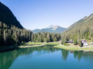 Nestled amidst the majestic mountains, this property offers stunning views of a serene lake.