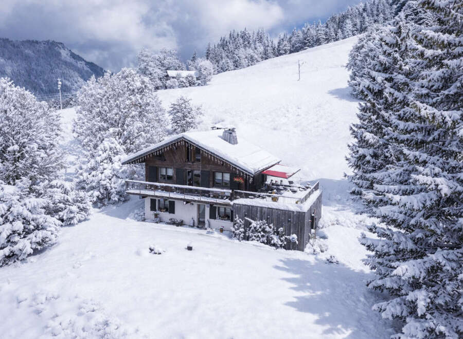 Nestled amidst a pristine winter wonderland, this charming chalet offers a serene escape.