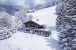 Nestled amidst a pristine winter wonderland, this charming chalet offers a serene escape.