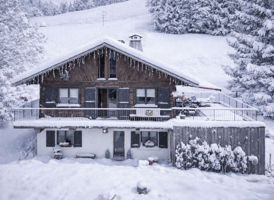 This charming chalet, nestled in a snowy landscape, offers a cozy retreat.