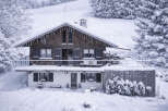 This charming chalet, nestled in a snowy landscape, offers a cozy retreat.