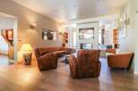 Step into luxury with this stunning property, featuring a cozy living room with a fireplace and stylish seating.