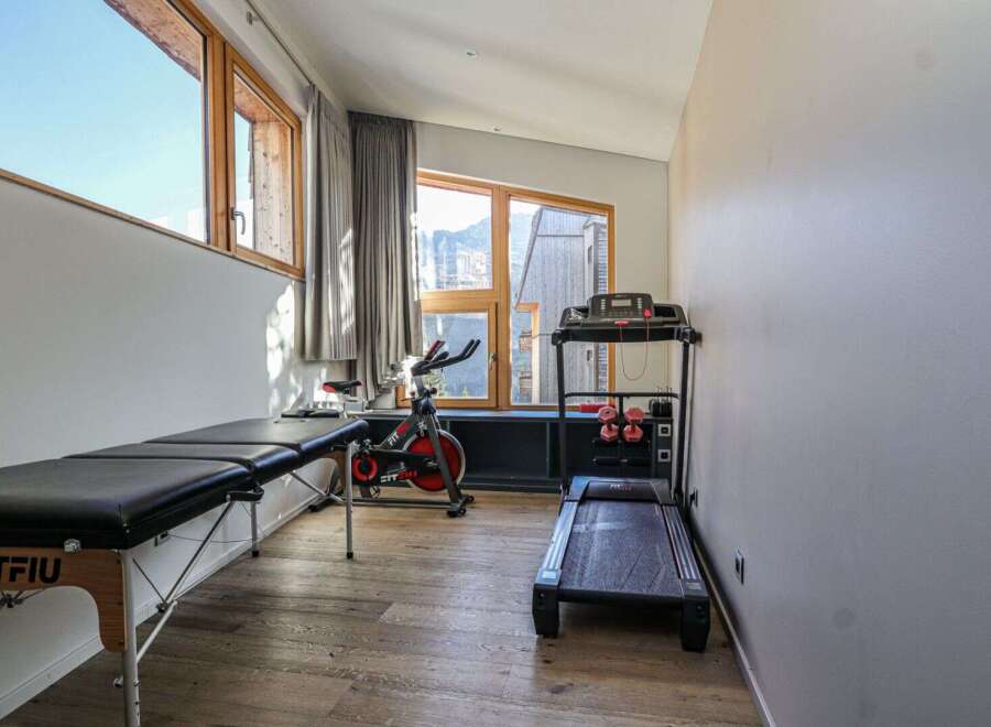 This well-equipped home gym offers a variety of fitness options.