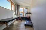 This well-equipped home gym offers a variety of fitness options.