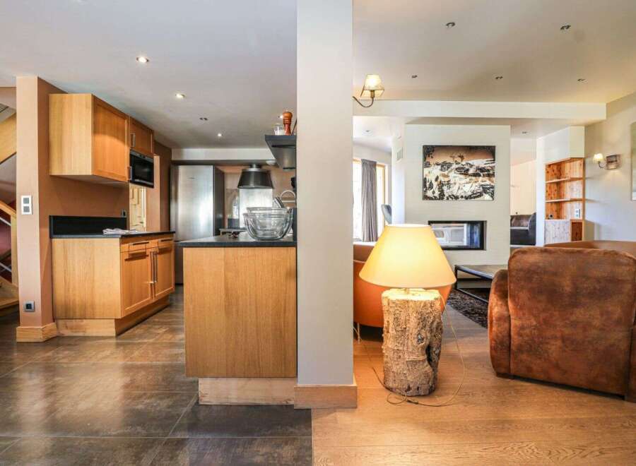 This stunning property boasts a modern kitchen with sleek cabinetry and stainless steel appliances, perfect for culinary enthusiasts.