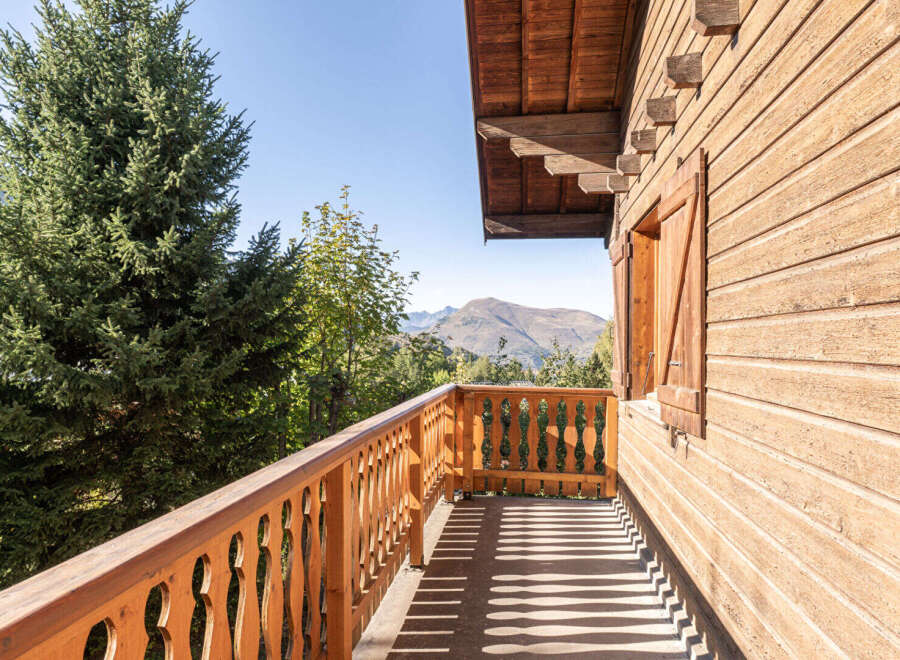 Enjoy breathtaking mountain views from this charming wooden balcony.