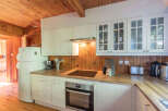 This charming kitchen boasts a warm and inviting atmosphere with its wooden accents and ample natural light.