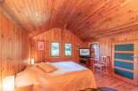 This cozy bedroom features beautiful wood paneling throughout, creating a warm and inviting atmosphere.