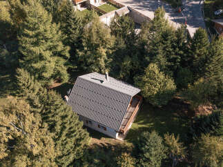 Nestled amidst lush greenery, this charming property offers a serene escape.