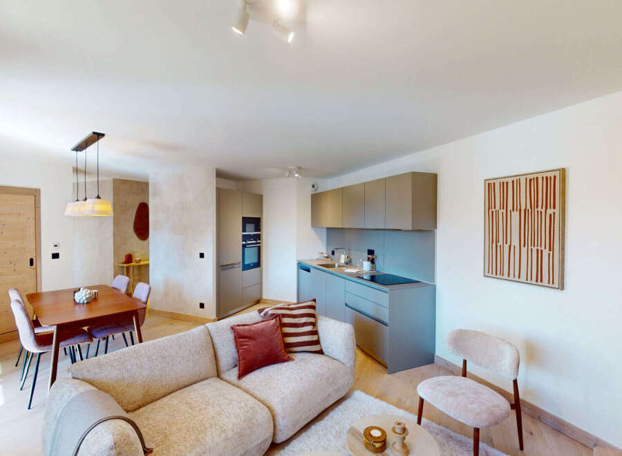 Experience modern living in this beautifully appointed apartment, featuring a sleek, integrated kitchen with ample cabinet space and a stylish dining area perfect for intimate meals.