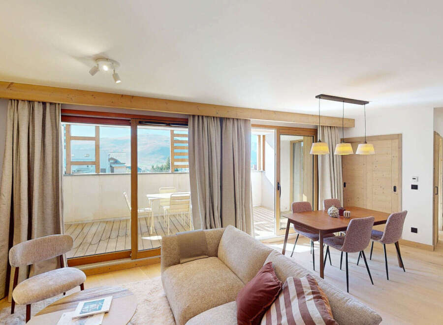 Experience modern mountain living in this beautifully appointed apartment, featuring a spacious open-plan living and dining area perfect for entertaining.