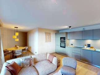 Experience modern living in this beautifully appointed apartment, featuring a sleek, integrated kitchen with state-of-the-art appliances and ample counter space.