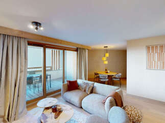 Experience modern living in this spacious apartment, featuring a comfortable living area with plush seating and a stylish dining space perfect for entertaining.