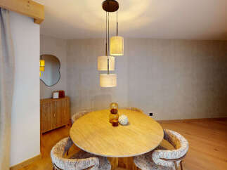 Experience elegant dining in this beautifully appointed space, featuring a round wooden table perfect for intimate gatherings.