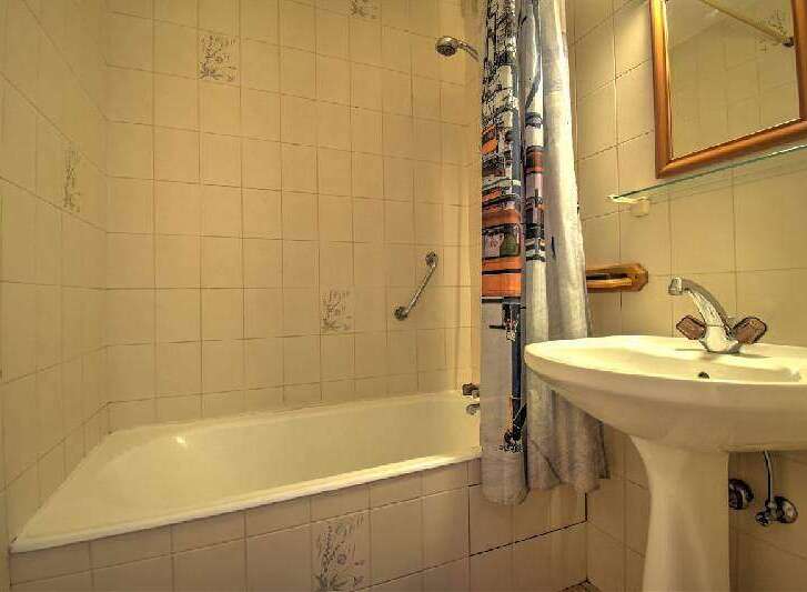 This cozy bathroom features a classic design with tiled walls and a functional layout.