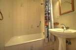 This cozy bathroom features a classic design with tiled walls and a functional layout.