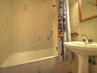This cozy bathroom features a classic design with tiled walls and a functional layout.