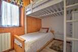 This cozy bedroom features a bunk bed, perfect for accommodating guests or family members.