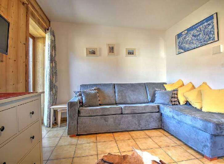 This cozy living space features a comfortable sectional sofa, perfect for relaxing after a day of exploring.