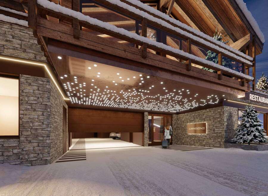 Experience luxury living in this stunning chalet, featuring a grand entrance with a unique lighting design.