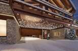 Experience luxury living in this stunning chalet, featuring a grand entrance with a unique lighting design.