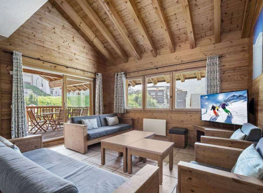 Experience the charm of this cozy living space, featuring a rustic wooden interior and a stunning view.