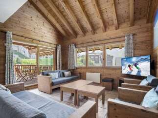 Experience the charm of this cozy living space, featuring a rustic wooden interior and a stunning view.