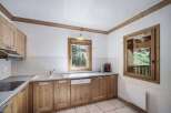This charming kitchen features wooden cabinetry and a bright, airy feel.