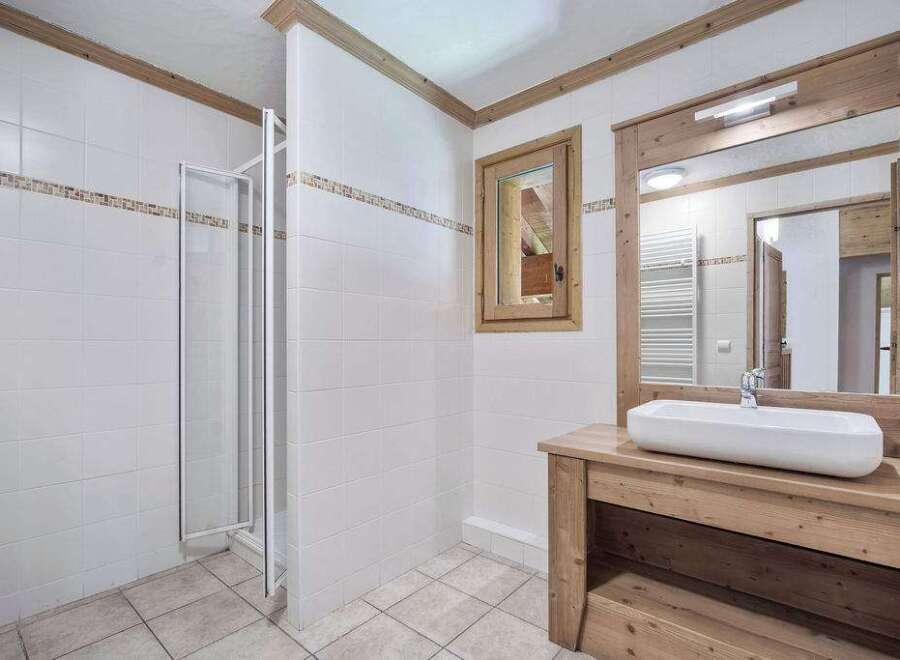 This charming bathroom features a modern design with a touch of rustic elegance.