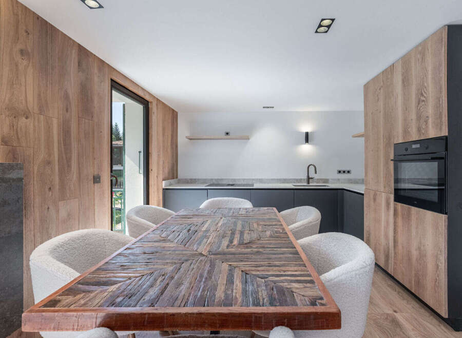 This stunning kitchen and dining area boasts a modern design with a touch of rustic charm.