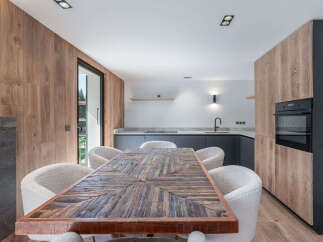 This stunning kitchen and dining area boasts a modern design with a touch of rustic charm.