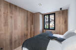 Experience the warmth and elegance of this stunning bedroom, featuring exquisite wood paneling that adds a touch of natural beauty.