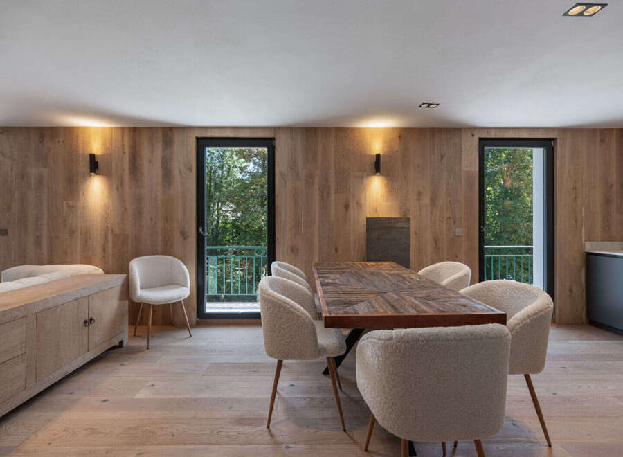 This stunning property boasts a modern dining area with a beautiful wooden table and stylish chairs.