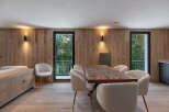 This stunning property boasts a modern dining area with a beautiful wooden table and stylish chairs.