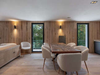 This stunning property boasts a modern dining area with a beautiful wooden table and stylish chairs.