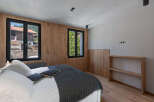 Experience the charm of this inviting bedroom, featuring natural wood accents and ample natural light.