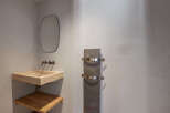 This modern bathroom features a sleek, minimalist design with a floating sink and a stylish towel warmer.
