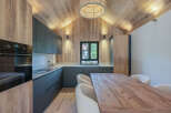 This stunning kitchen boasts a modern design with a rustic touch, perfect for any home.