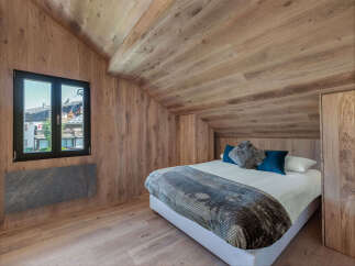Experience the charm of this stunning bedroom, featuring exquisite wooden accents throughout.