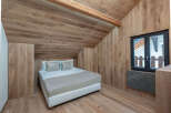 This cozy bedroom features a unique wooden design, creating a warm and inviting atmosphere.