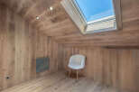 This stunning room features a unique design with wooden walls and ceiling, creating a warm and inviting atmosphere.