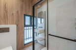 This modern bathroom boasts a sleek design with a glass shower enclosure and a stylish vanity.