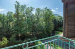 Enjoy breathtaking views from this charming property! This home features a private balcony overlooking lush greenery and a serene landscape.