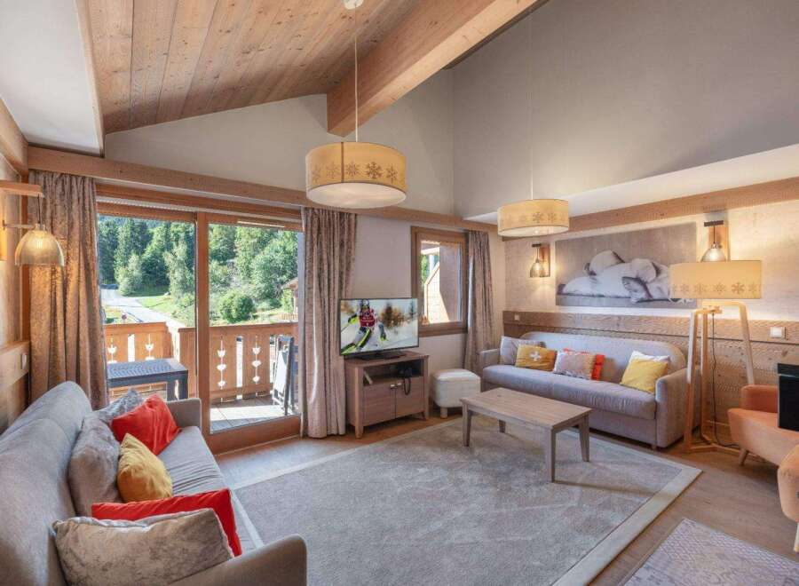 Experience luxury living in this stunning property, featuring a spacious living room with a cozy fireplace and large windows.