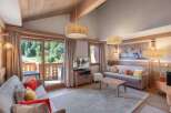 Experience luxury living in this stunning property, featuring a spacious living room with a cozy fireplace and large windows.