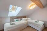 This cozy bedroom features two twin beds, perfect for guests or a shared living space.