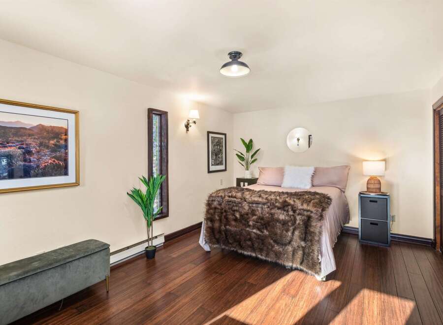 This cozy bedroom features a plush, fur-like blanket atop a comfortable bed, creating a warm and inviting atmosphere.